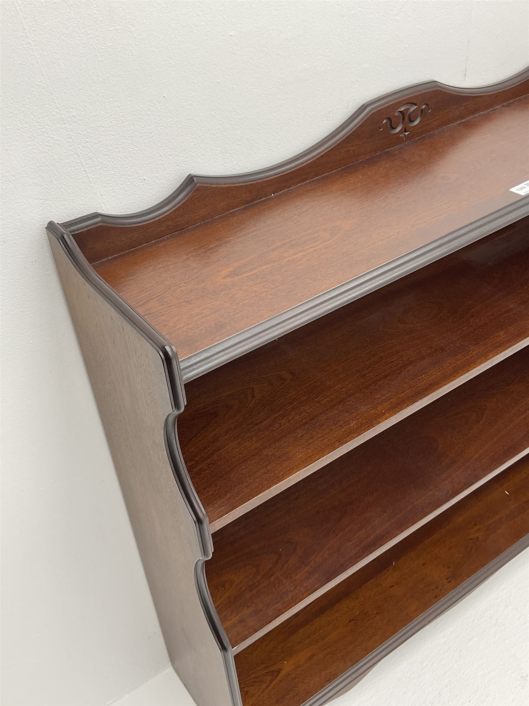 Rossmore Furniture - mahogany bookcase fitted with four shelves, shaped end supports