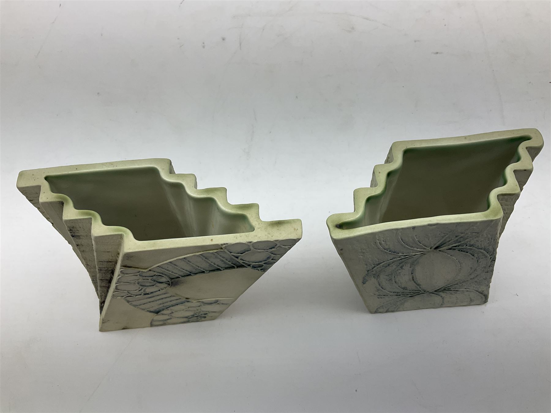 Pair of Carn Pottery Penzance vases of fan form, with tube lined floral and stylised decoration, stamped and marked X9 to base, H11.5cm