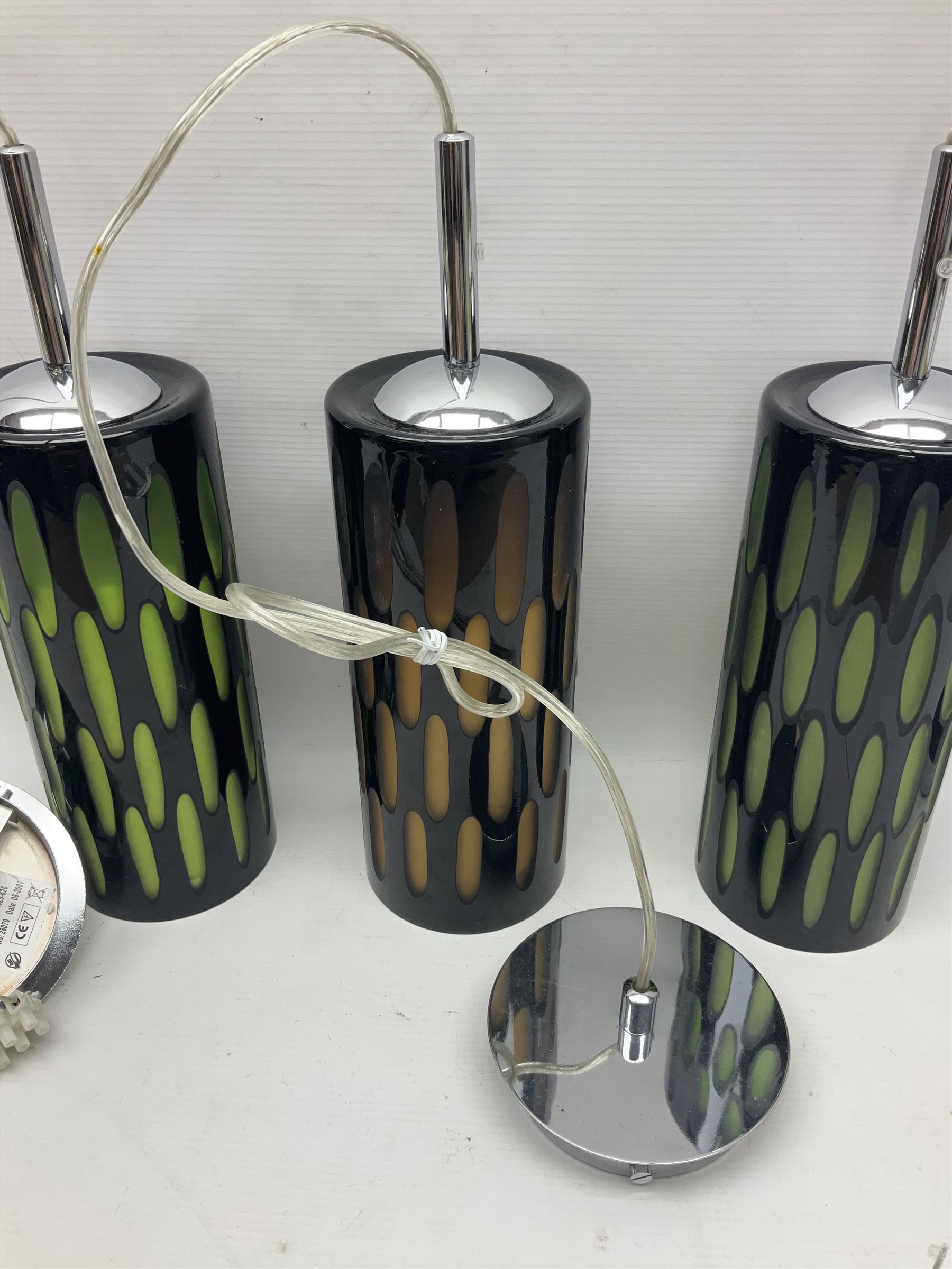 Three contemporary glass pendant lights, the black glass glass cut away revealing green and brown beneath, H24cm