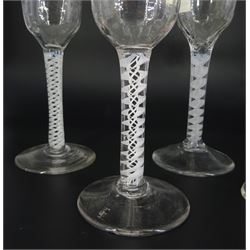 Five 18th century drinking glasses, with ogee part moulded bowls, three examples upon double series opaque twist stems, two examples upon single series opaque twist stems, and all upon conical feet, each approximately H14cm