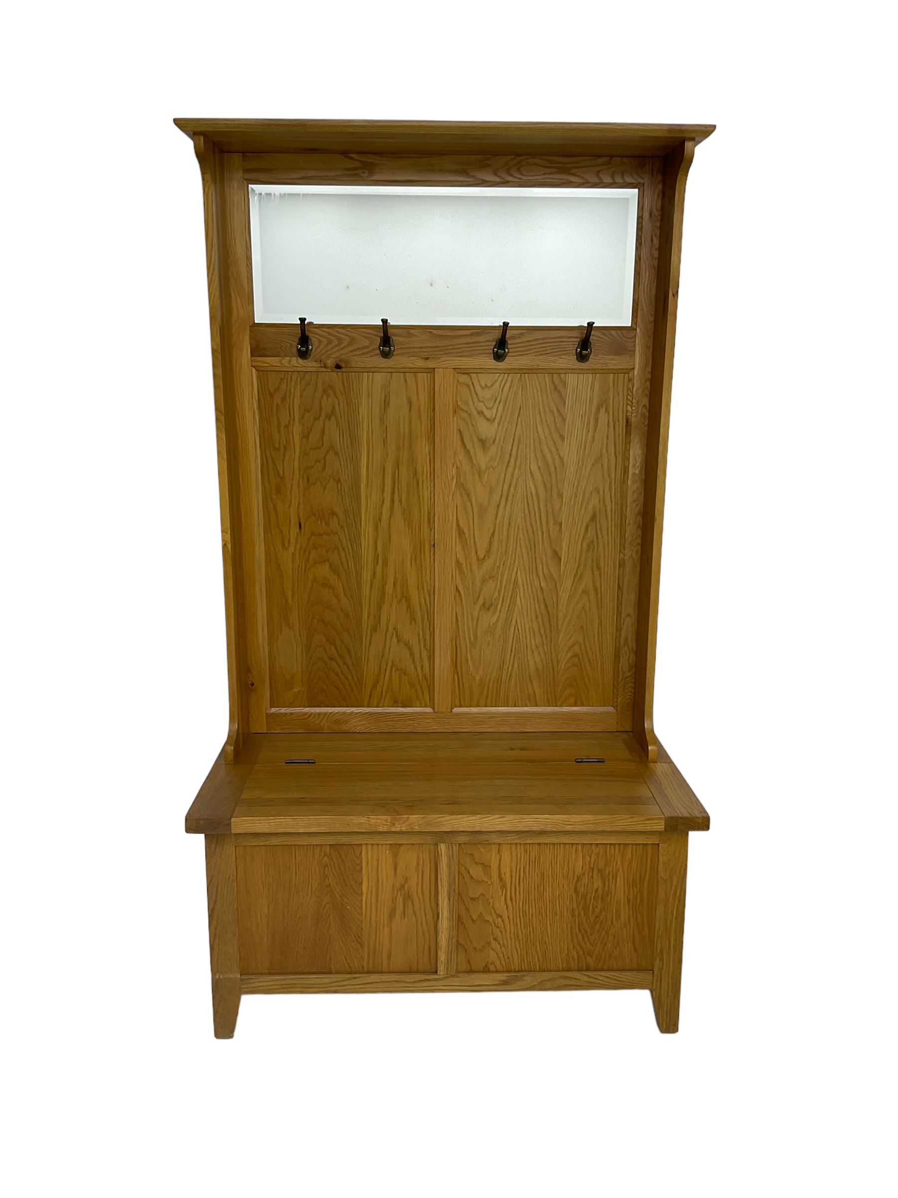 Oak mirror-back hall bench, projecting cornice, rectangular bevelled plate over four coat hooks, hinged box seat compartment with panelled front, on square tapering feet