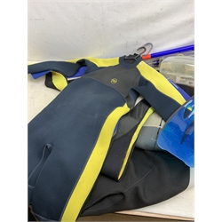 A collection of assorted sized wetsuits, comprising examples, by Osprey, Saltrock, TWF, Alder, Banana Bite, together with four pairs of flippers, three masks and snorkels, and a Buddy Commando Profile BCD vest. 
