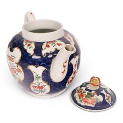 18th century Worcester teapot, circa 1763-70, of globular form, painted with shaped panels of chrysanthemums and banded hedges on a blue scale ground, cover with flower finial, mark beneath, H15cm