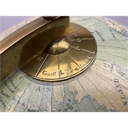 Terrestrial globe by Grinell, Washington, mounted on a brass half meridian and raised on turned wood pedestal base, H55cm