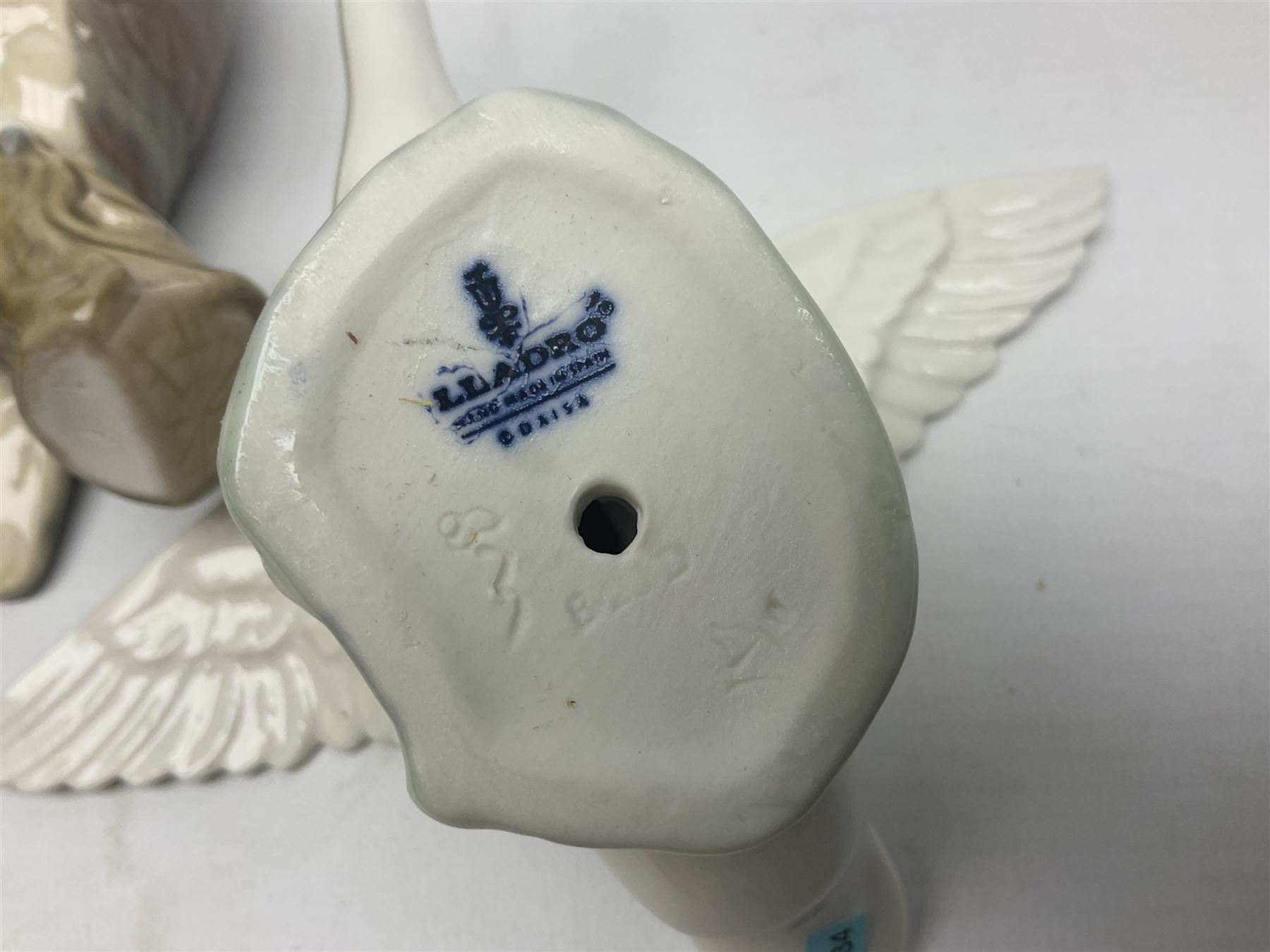 Lladro figures of animals, comprising Mini Lion no 5436, Beautiful Burro no 5683, Hawk Owl no 5422, Beagle Puppy Sitting no 1071, Duck Flying no 1264, Miniature Cat no 5308 and Small Papillon Dog no 4749, four with original boxes, largest example H14cm