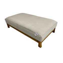 Large rectangular stained beech footstool upholstered in cream fabric