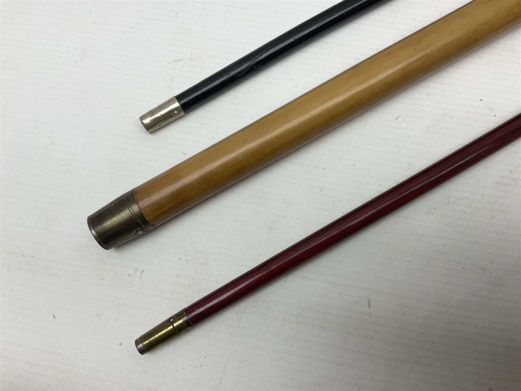 Three parade ground canes - malacca cane Coldstream Guards with plated mount engraved 'H.A. Myhan' L87cm; ebonised Church Lads Brigade 'Fight The Good Fight'; and mahogany stained Worcestershire Regiment (3)