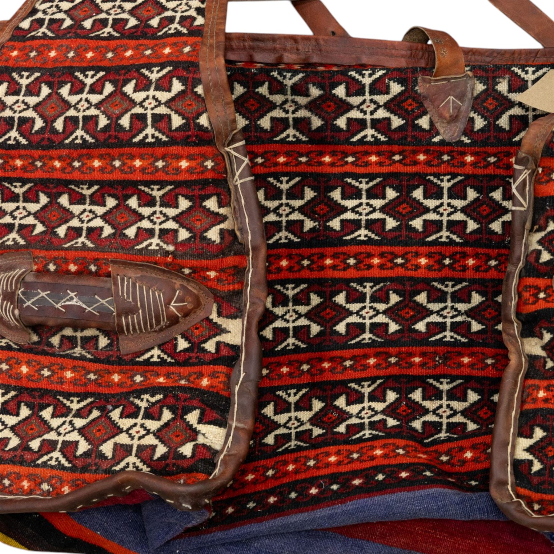 South West Persian Qashqai bag, woven body decorated with bands of geometric motifs in red, ivory and dark tones, with leather fittings and straps, underside with flatweave stripped bands 