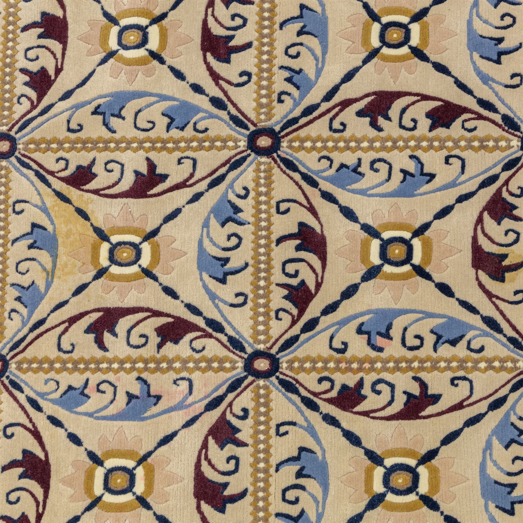 Rugs by Design - Nepalese wool rug, cream field decorated with repeating diamond trellis enclosing scrolling foliate motifs in blue, burgundy and ochre, within chain-link border and fringed ends