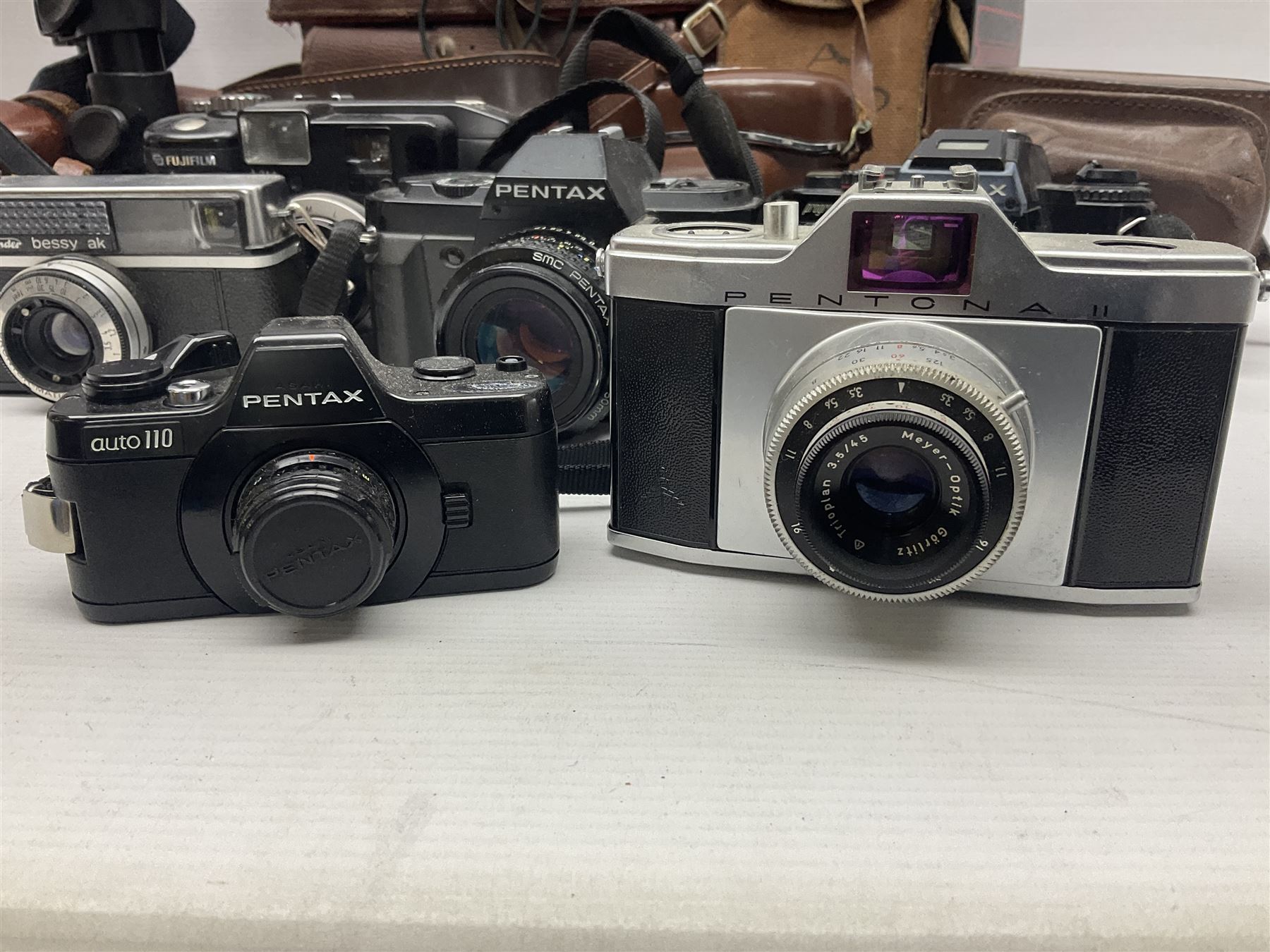 Collection of cameras and lenses, to include Pentax Program A camera body, serial no 123759, with 'Pentax-A zoom 1:3.5-4.5 28-80mm' len, Praktica EE2 camera body with 'Pentacon electric 1.8/50' lens etc, together with a Manfrotto tripod 