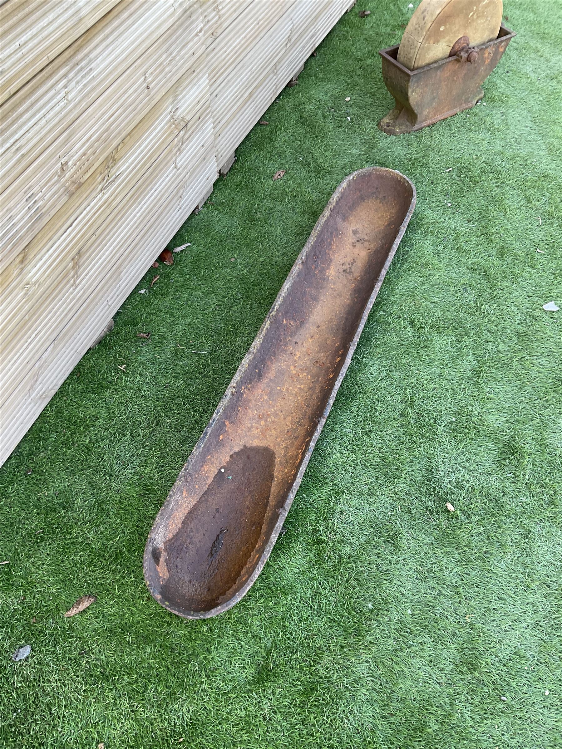 Small stone sharpening wheel, and a shallow cast iron trough - THIS LOT IS TO BE COLLECTED BY APPOINTMENT FROM DUGGLEBY STORAGE, GREAT HILL, EASTFIELD, SCARBOROUGH, YO11 3TX