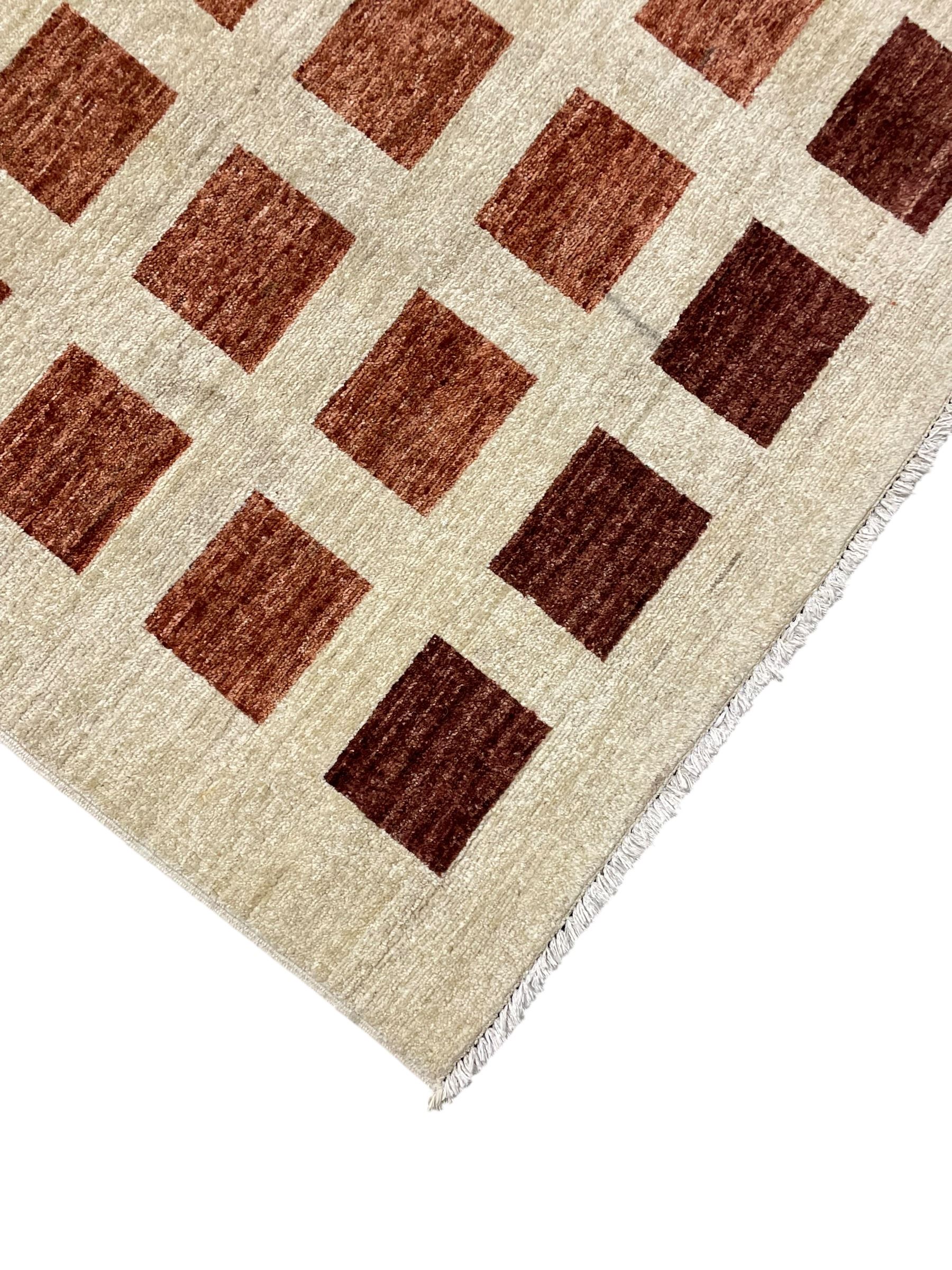 Contemporary camel ground woollen rug, decorated with gradient squares in shades of terracotta 