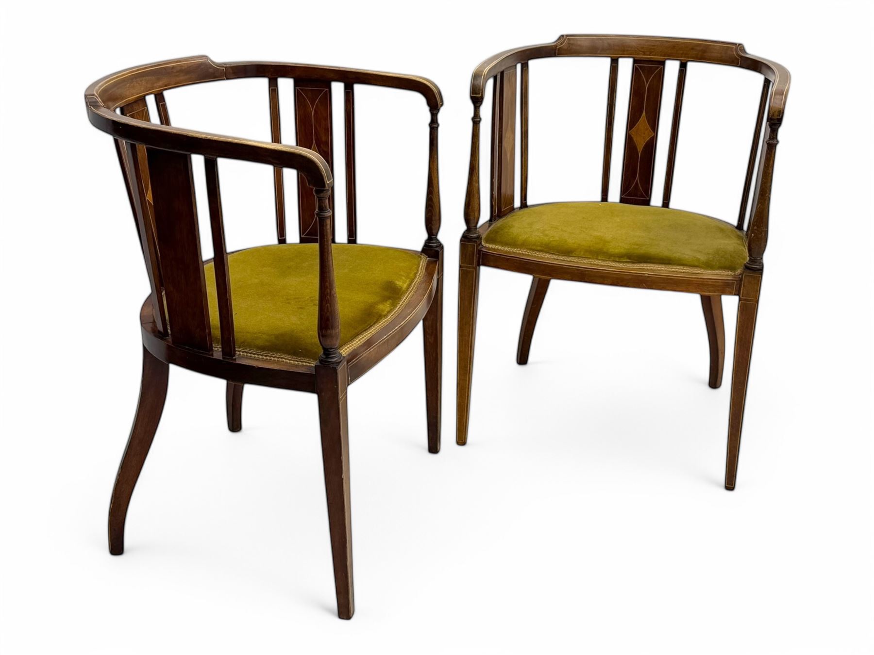 Pair of early 20th century Edwardian inlaid mahogany elbow chairs, shaped top rails with central diamond motif and line inlays, flanked by turned uprights, green velvet seats, on square tapered legs