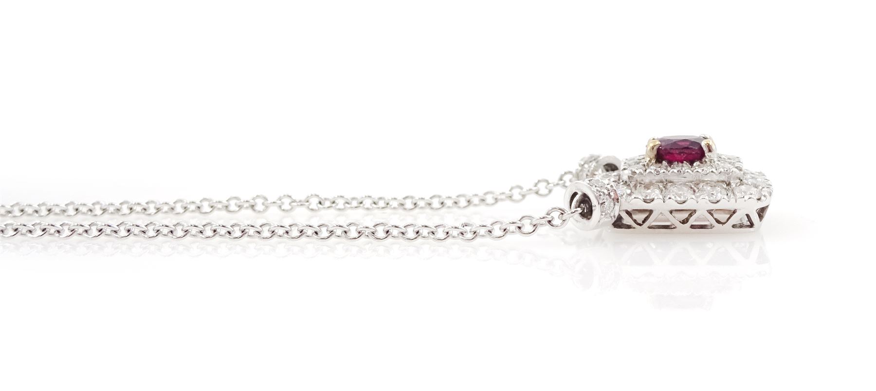 Platinum ruby diamond cluster pendant necklace, single oval cut ruby in a four claw 18ct rose gold setting of approx 0.58 carat, surrounded by two rows of round brilliant cut diamonds, London 2018, total diamond weight approx 0.84 carat, with Alan Poultney Gems report