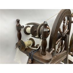 Two vintage beech spinning wheels, largest example H92cm