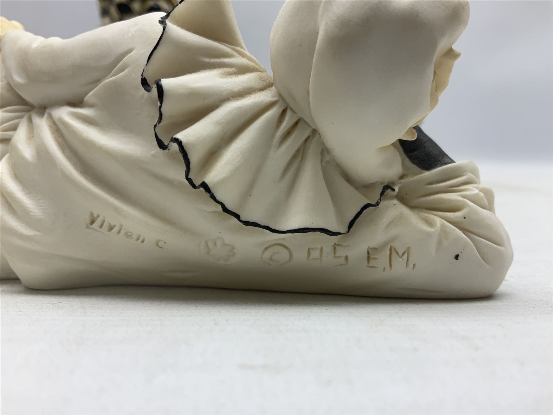 Pair of early-mid 20th century figural composite bookends modelled as harlequin court jesters sat upon stacks of books, H20cm together with a figure of a jester signed Vivian C (3)