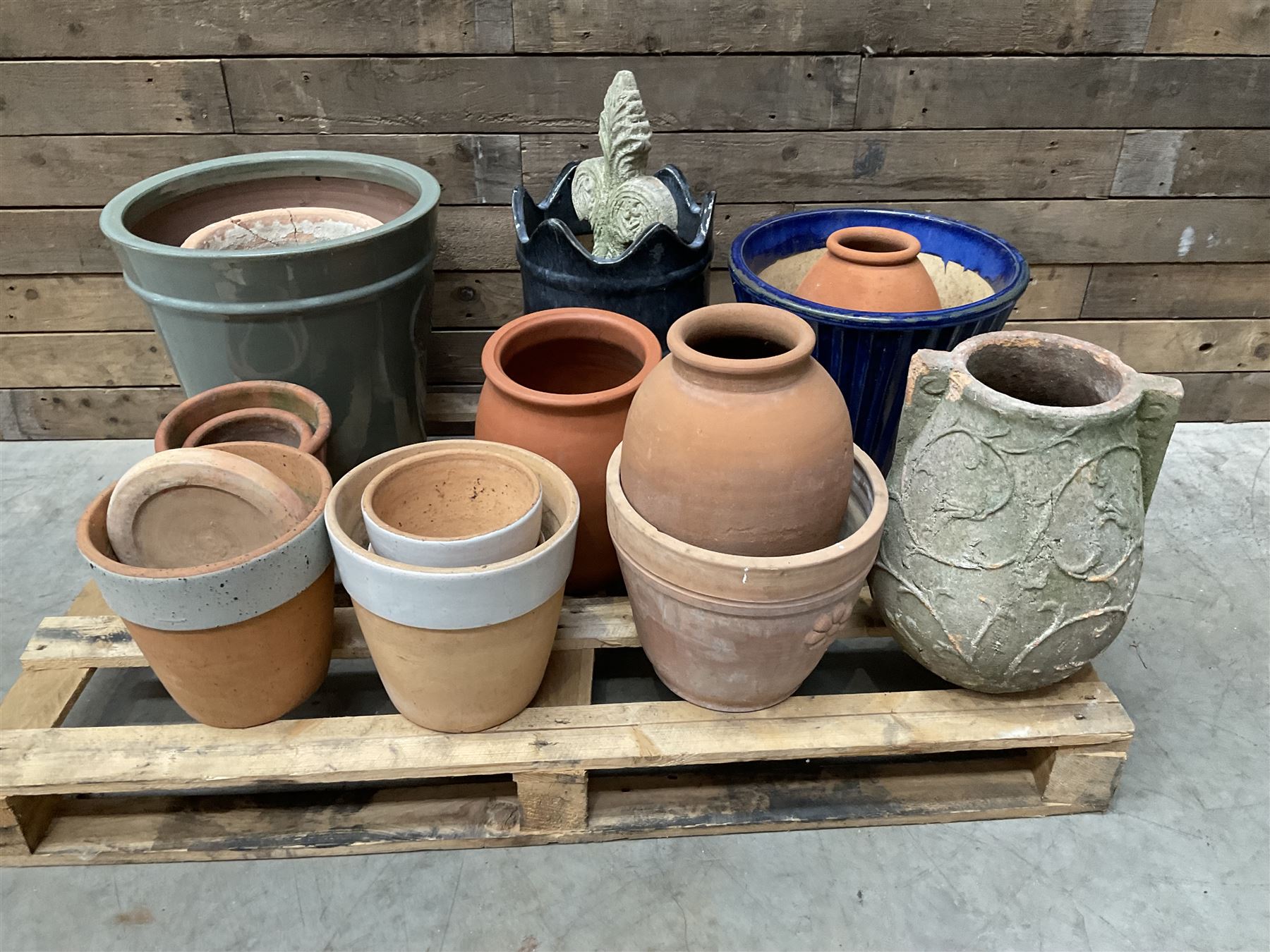 A quantity of various terracotta and glazed planters