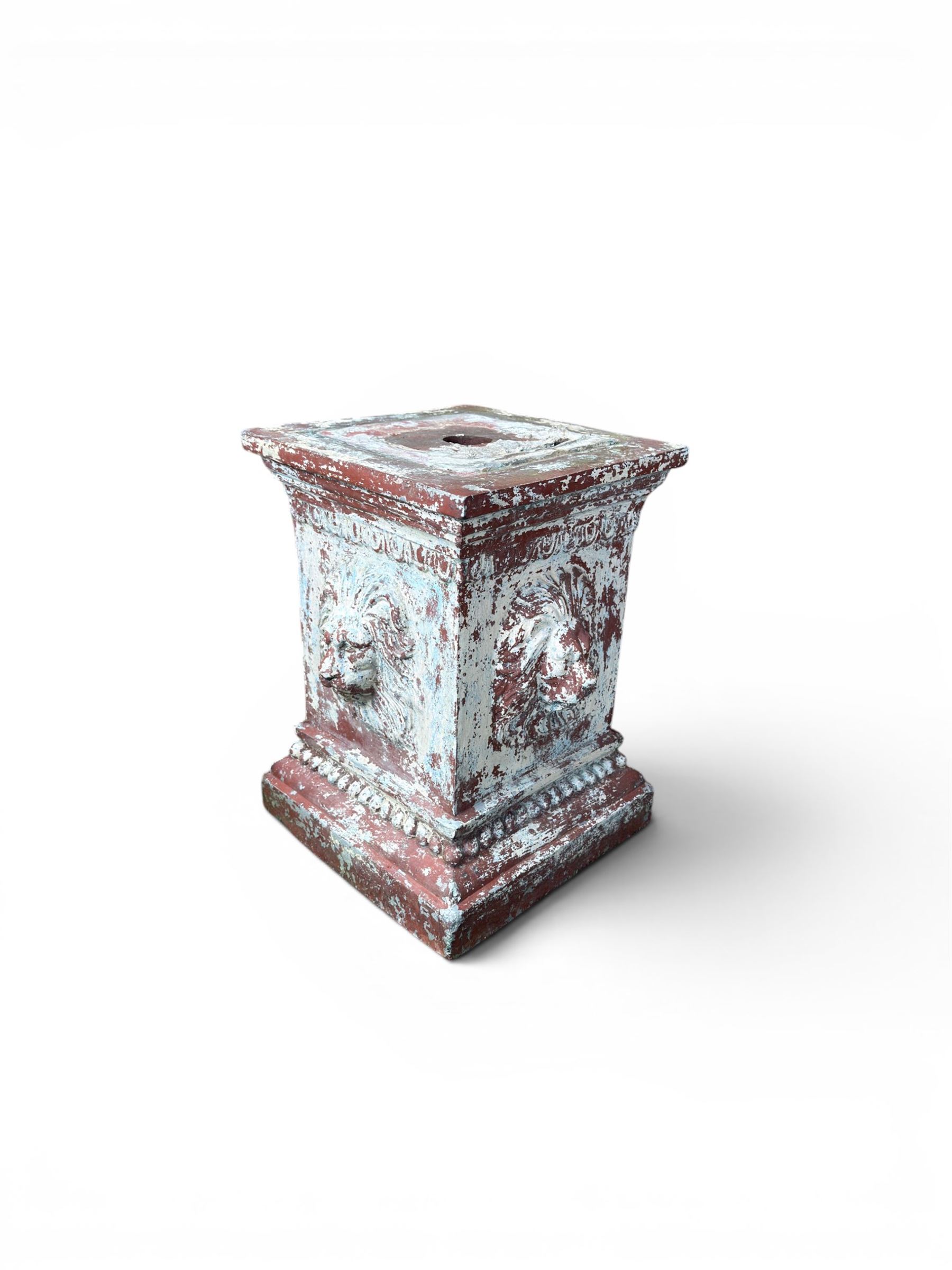 Early 20th century terracotta pedestal, square form with egg and dart detail, four lions masks to either side, finished in distressed cream paint