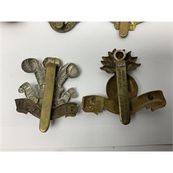 Fourteen cap badges of Irish interest including Royal Dublin Fusiliers inscribed to the slider 'From A. O'Connor 2nd Batt. Dec.2nd 1915', Connaught Rangers, South irish Horse Yeomanry, Inniskilling Fusiliers, Royal Irish Regiment etc; and seven Welsh badges including South Wales Borderers, Welsh Guards, 3rd Bn. Monmouthshire Regt. etc (21)