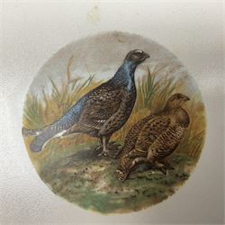 Four Minton tiles decorated with game birds, with another similar example, each within a metal frame H17cm