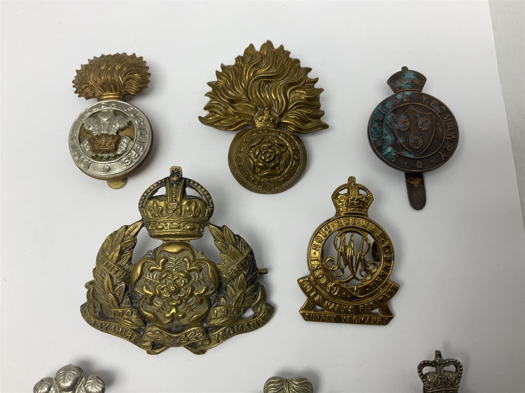 Nineteen Yeomanry metal cap badges including Derbyshire, Northamptonshire, Essex, Glamorgan, Staffordshire, City of London, Surrey, Shropshire, Hertfordshire etc; together with eleven Fusiliers badges including Lancashire, Royal Welch, Northumberland etc (30)