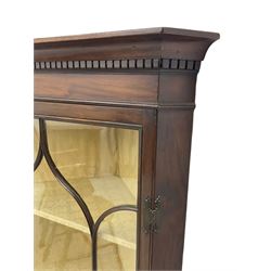 Early 20th century Georgian design mahogany wall-mounted corner display cabinet, projecting cornice with dentil frieze over astragal glazed door enclosing three fabric-lined shelves
