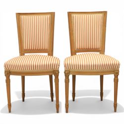 20th century Louis XVI style beech salon suite, comprising settee and four chairs, the settee with shaped rectangular back and upholstered arms over a shaped seat, the chairs with rectangular backs and overstuffed seats, each upholstered in striped fabric with close-nailed borders, upon fluted tapering supports headed by carved paterae, terminating in toupie feet, chairs H89cm W47cm