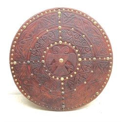  Replica Scottish Highlander's Targe by Joe Lindsay, based on a 17th century original which came from Skye, the wooden shield covered in tooled leather with traditional Celtic designs, brass studs and mounts with deer skin hide verso, D49cm   