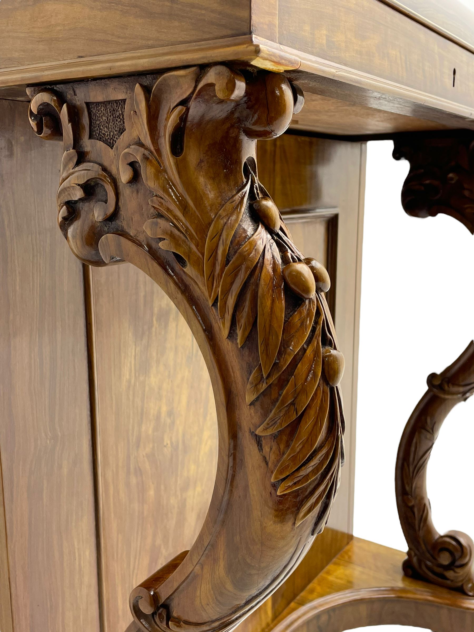 Fine and unusual 19th century olivewood piano top davenport, raised shaped back carved with olive branches and olives, the top hinges to reveal lidded and correspondence compartments, the piano lid enclosing sliding top with hinged and adjustable writing surface with leather inset, right-hand panelled door enclosing four drawers, olive branch and scroll carved cabriole front supports on moulded and shaped platform, turned cup feet with recessed castors 