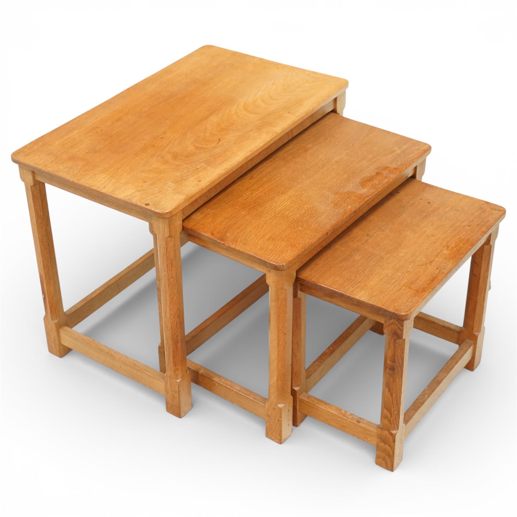 Mouseman - oak nest of three tables, raised on octagonal supports, with carved mouse signature, by the workshop of Robert Thompson of Kilburn