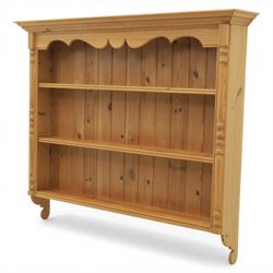 20th century country style waxed pine hanging wall shelf, with projecting cornice, over three fixed delf racks, flanked by applied turned columns, with brass wall hangers