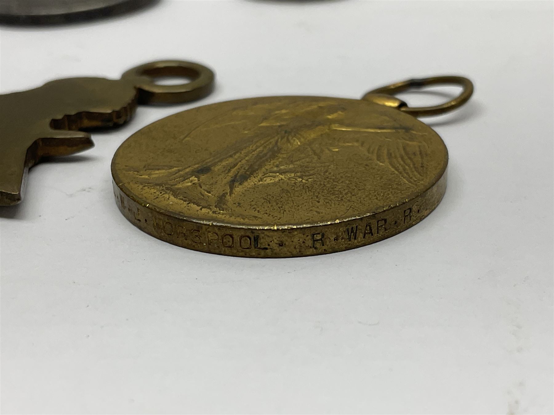 WW1 group of three medals comprising 1914-15 Star awarded to L-Cpl. W.J. Horspool R.War.R., British War Medal and Victory Medal awarded to A. Cpl. W.J. Horspool R.War.R.; WW1 British War Medal awarded to 3-8755 W.O.Cl.2. S. Paterson North'd Fus.; and hallmarked silver and enamel Northumberland Football Association Junior Cup Runners Up fob 1921-22 on silver chain (5)