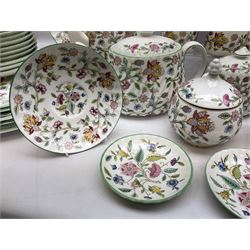 Minton Haddon Hall pattern tea and dinner wares, including basket dish, two covered tureens, six dinner plates, eight dessert plates, twelve tea plates, six soup bowls, six cereal bowls, teapot, coffee pot, milk jug, covered sucrier twelve tea cups and saucers, six mugs, footed bon bon dish, pair of candlestick holders, cake knife and slice etc (81)