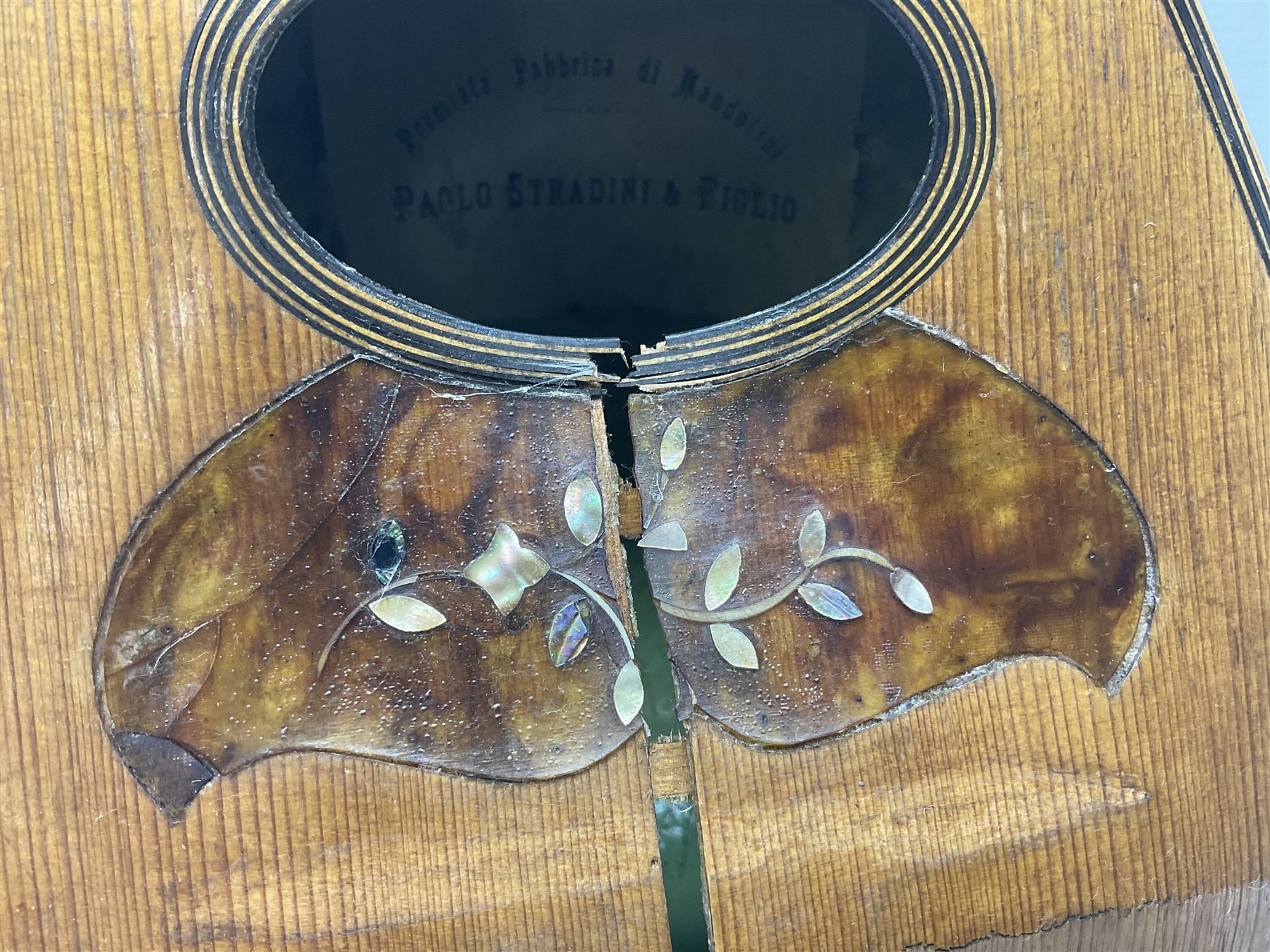 Late 19th century Italian lute back mandolin with segmented bowl back, bears label Gennaro Maglioni Napoli L61cm; in ebonised wooden case; together with another similar damaged Italian lute back mandolin for restoration or spares (2)