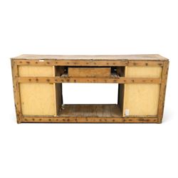 18th century rustic oak dresser base, with fielded panels and iron cup handles with embossed greek key and foliate detail, three short drawers above and open recess flanked by two cupboard doors, raised on stile supports