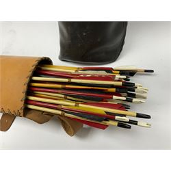A large collection of assorted various arrows, in two quivers, plus a stand with part of bow. 