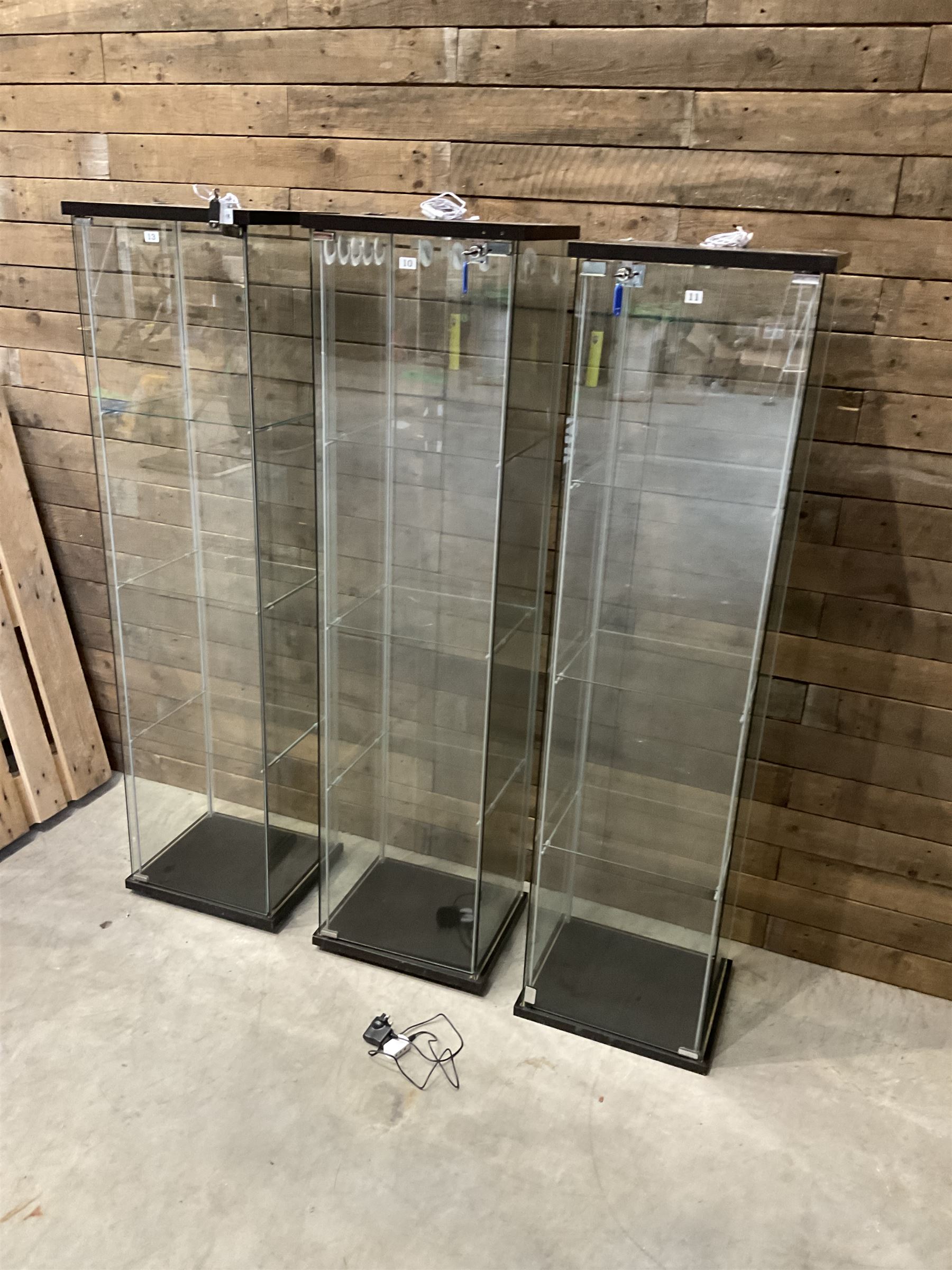 Three Ikea rosewood finish illuminated four glass shop display cabinets, with shelves and keys