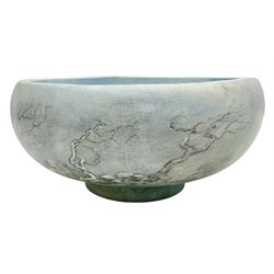 Wooden hand painted bowl, decorated with trees on a blue ground, signed Phil Crennell beneath, D28cm