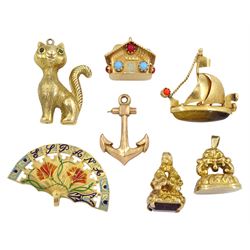Three 18ct gold pendant/charms including tigers eye and stone set ship, stone set house and 'Espana' and four 9ct gold pendant/charms including cat, fob, purple stone set fob and anchor