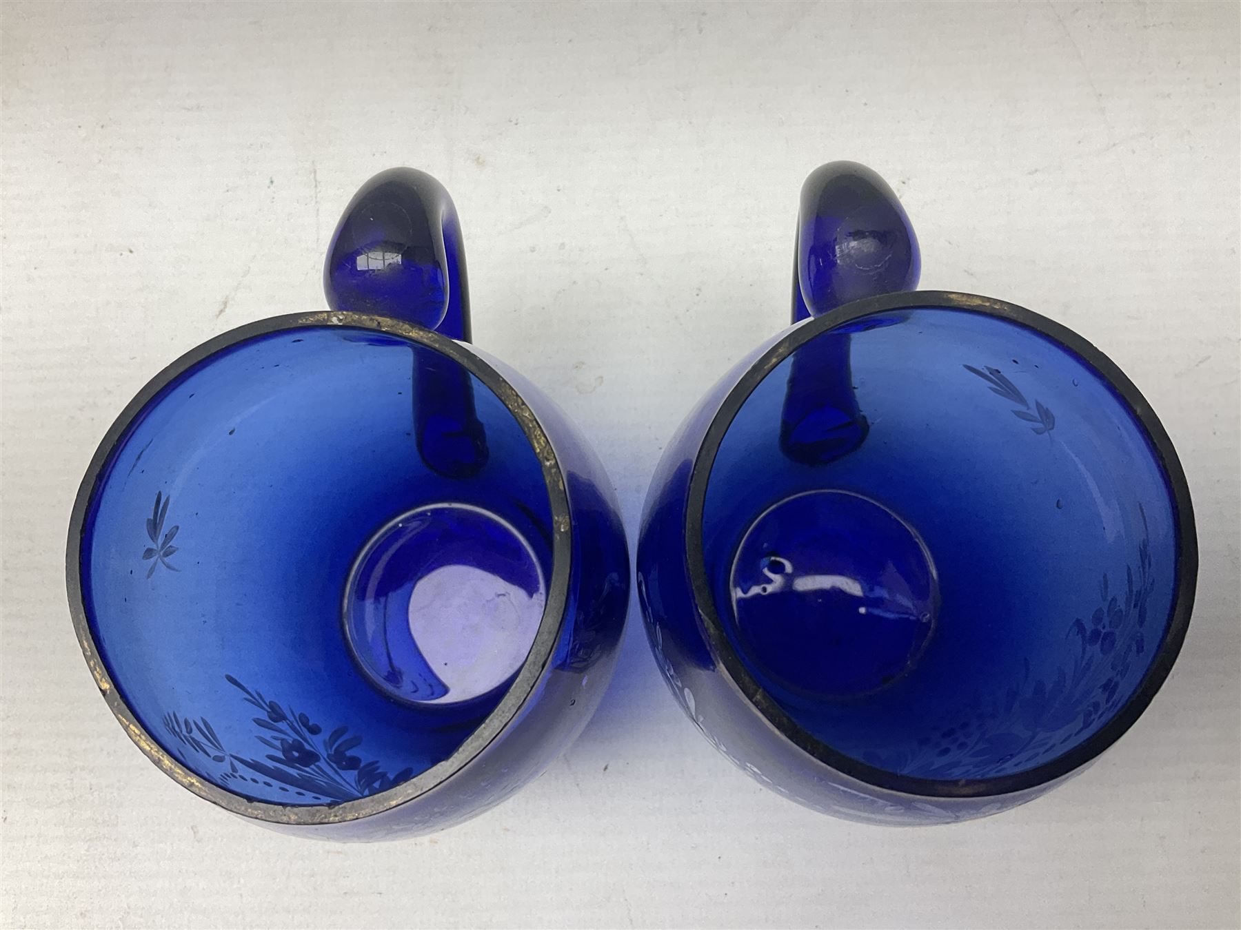 Pair of Victorian cobalt blue glass cups with gilt and painted decoration, entitled Hope's the Balm of Life and Love me as I Love Thee, H8.5cm