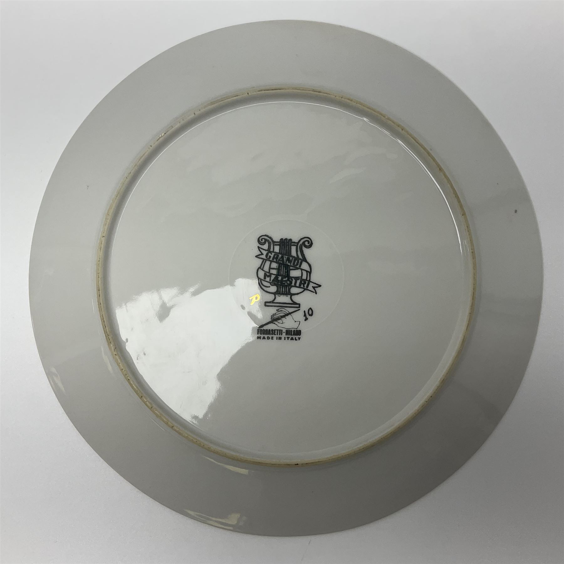 Fornasetti Grandi Maestri plate, depicting Giuseppe Verdi within a border of operatic emblems on gilt ground, with printed mark beneath, D25cm