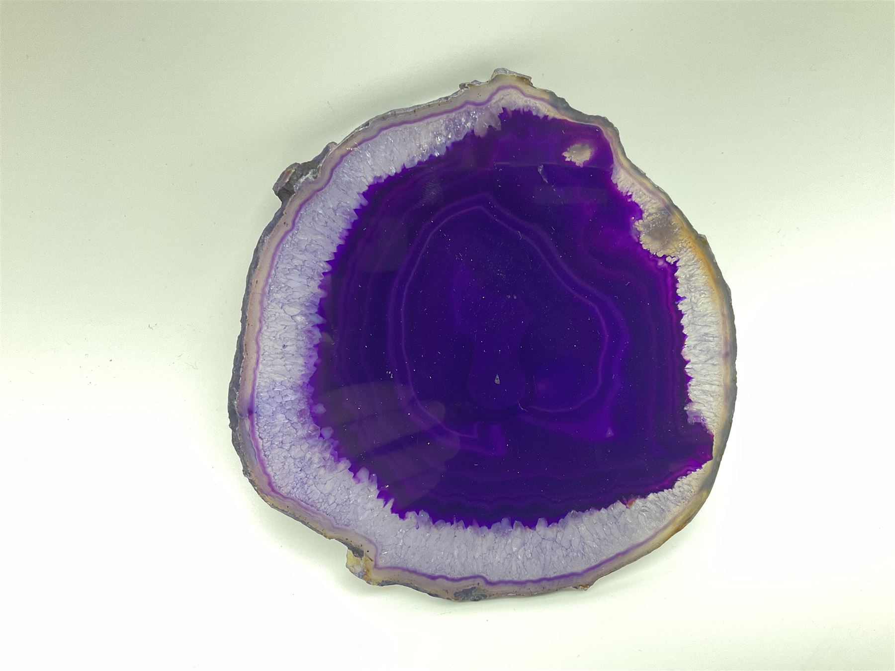 Pair of purple agate slices, polished with rough edges, raised upon gilt metal stands