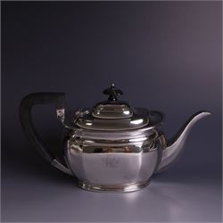 1930s silver four piece tea service, comprising teapot, hot water pot, sugar bowl and milk jug, each of part faceted oval form with engraved monogram to body, the teapot and hot water pot with Bakelite type handles and finials, hallmarked Atkin Brothers, Sheffield 1933