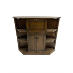 Early 20th century oak bow-front bar, the front uprights carved with lozenges and geometric decoration, the reverse fitted with fall-front drinks cabinet over double cupboard, flanked by four open shelves; together with circular seat bar stool ,(W31cm H65cm)