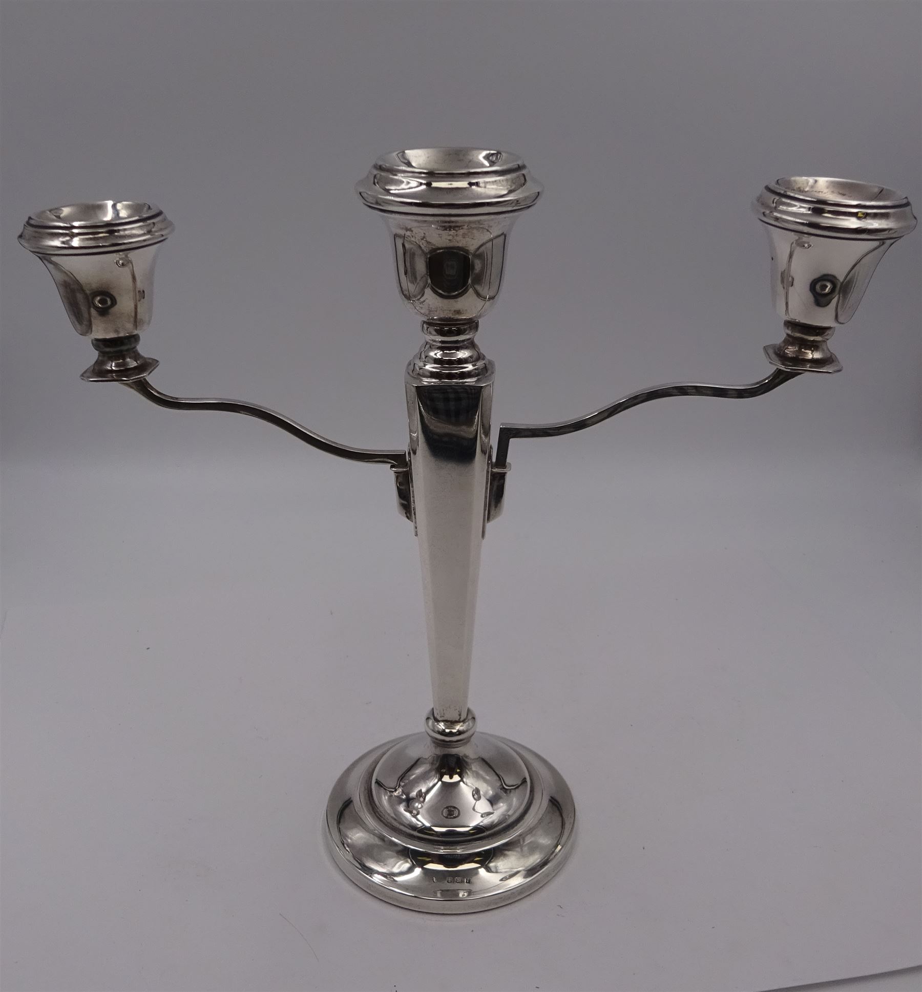 Modern silver mounted three branch candelabra, the tapering stem supporting a central candle holder and two removable curved branches with candle holders, upon spreading circular foot, hallmarked Birmingham 1968, maker's mark worn and indistinct, H25.5cm