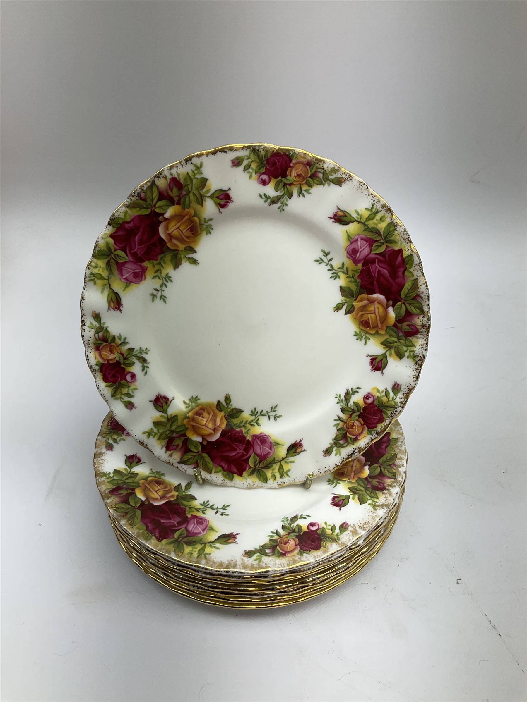 Royal Albert Old Country Roses part dinner and tea service comprising teapot, four tea cups and saucers, eight dessert plates, cake plate, cake stand, a tureen with cover, six dinner plates, an oval dish, two trinket dishes, bell and shoe decoration. 