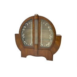 Art Deco walnut display cabinet, of circular design, fitted with two shaped glazed doors enclosing two glass shelves, flanking five glass rods