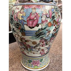 Large pair of 19th century Cantonese famille rose vases, each painted with various courtly scenes, including a display of warriors fighting on horseback before an official and his attendants, double Buddhist lion handles and applied at the shoulders with chilong, the lower band painted with Greek key motif, H58cm (2)