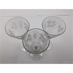 Set of three 18th century style wine glasses, each with funnel bowl etched with fruit vine, upon a double series air twist stem and circular foot, H17cm