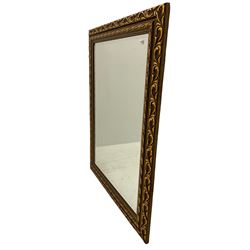 Rectangular wall mirror in leaf moulded bronze/gilt frame, bevelled plate